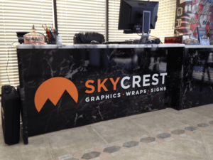 particle board desk wrapped in marble design with logo
